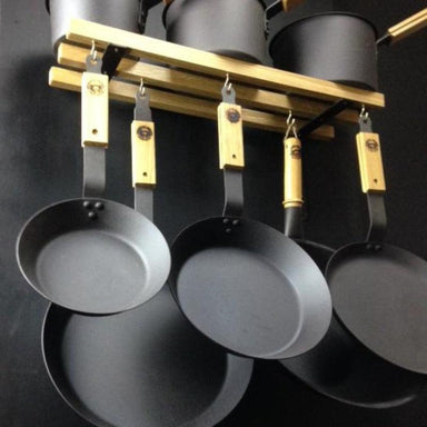 Lifestyle shot of hanging Netherton Foundry Ultimate Pan Set including Oak Pan Storage Rack