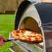 Front view of Igneus Pro 600 with door open cooking pizza