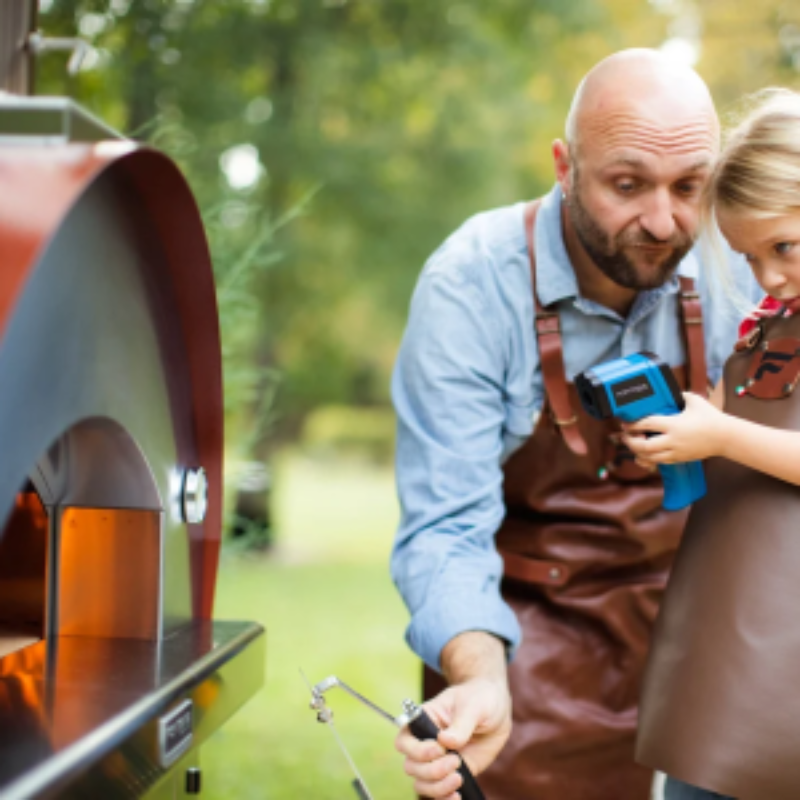 Lifestyle shot of Fontana Margherita Rosso Build In Wood Pizza Oven in rosso