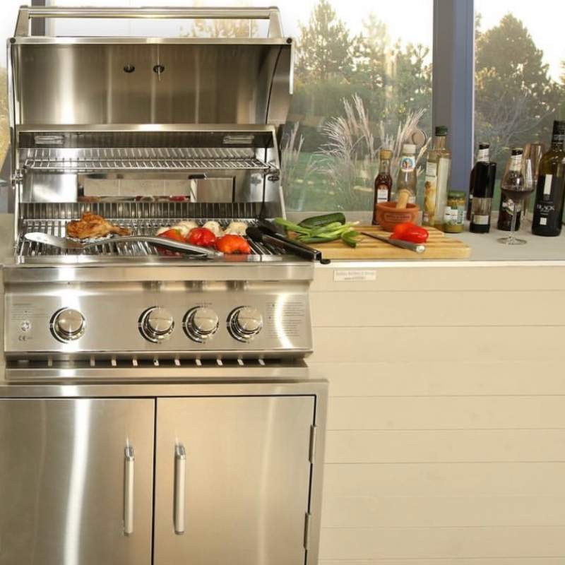 Lifestyle view and grill open of Whistler Burford 3 Burner Barbecue with Rotisserie and Weather Cover  