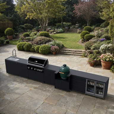 Outdoor kitchen setup with a grill and refrigerator in a garden setting