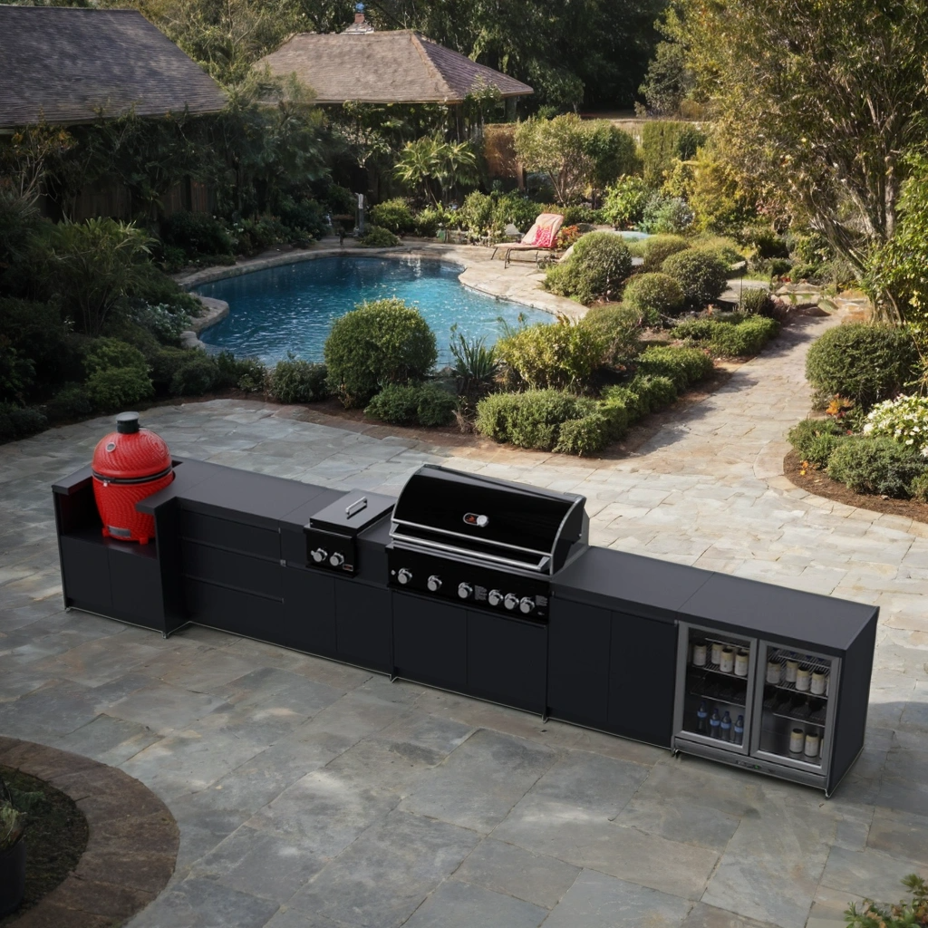 Whistler Outdoor kitchen with barbecue and refrigerator next to a pool