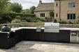 Whistler grills Outdoor kitchen with grill and sink in a garden setting